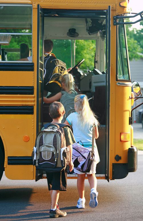 students getting on bus